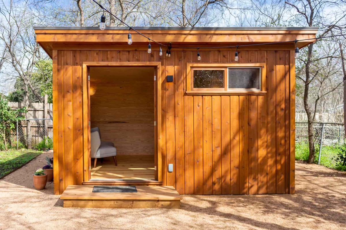 Backyard cedar urban studio home studio design 12' x 14' with open French double doors and sliding clear window as seen from the front. Id number 5750.