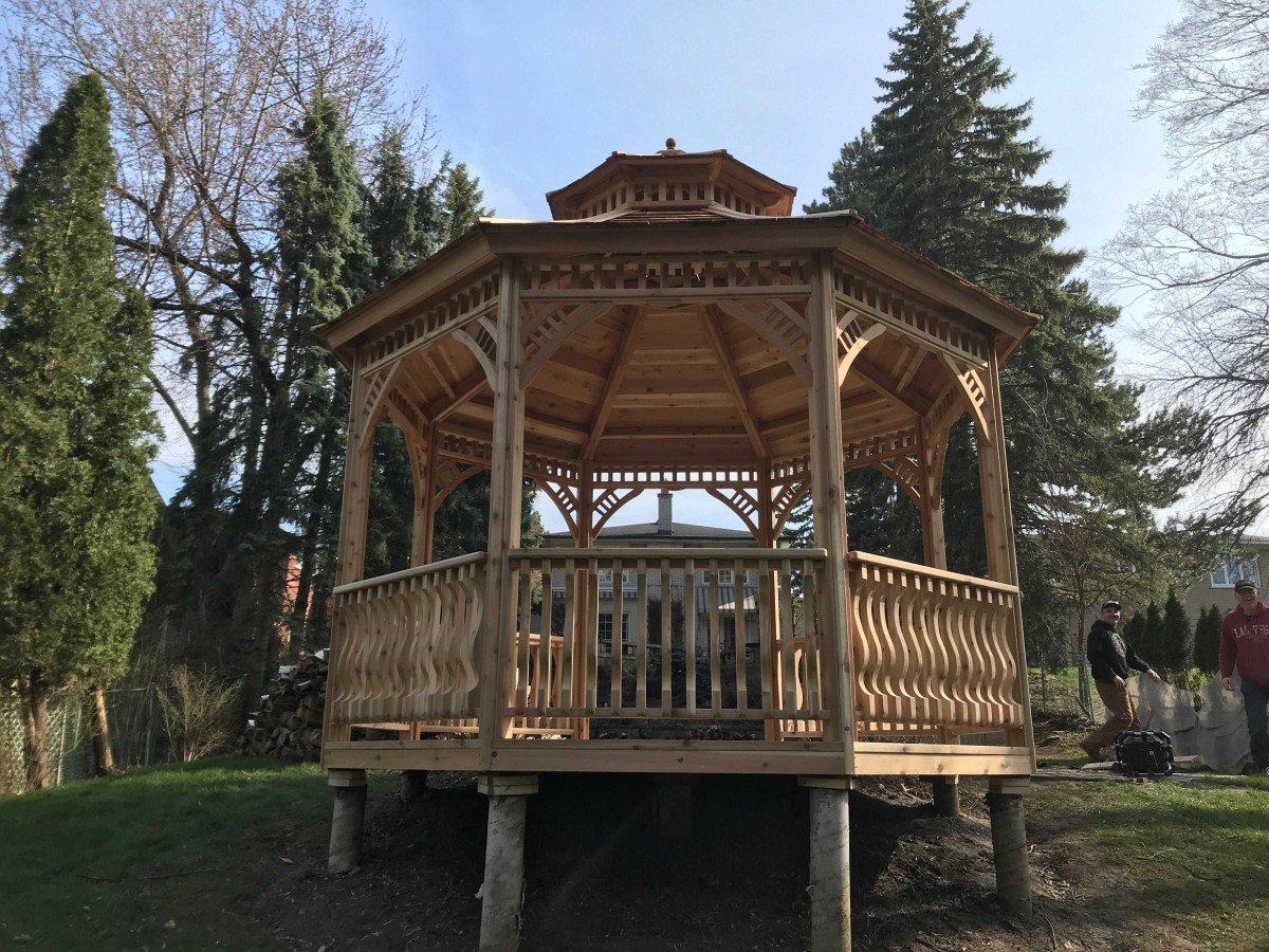Backyard gazebo design 12' with cedar shingles and natural finish as seen from the rear. Id number 5736.