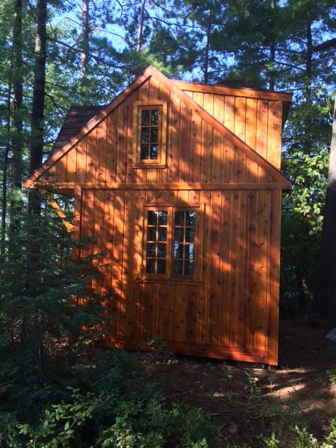 Bala Bunkie cabin design with a fan arch window and a shed dormer in woods seen from the side2. ID number