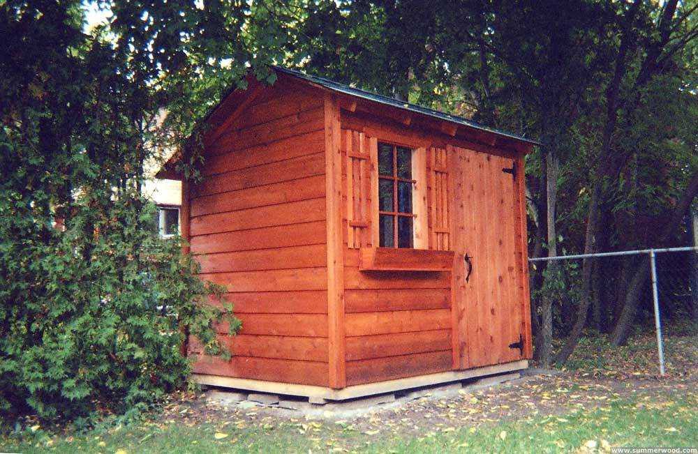 Bar harbor shed design 6 x 8 in a backyard with a standard door seen from the side. ID number 1483-3