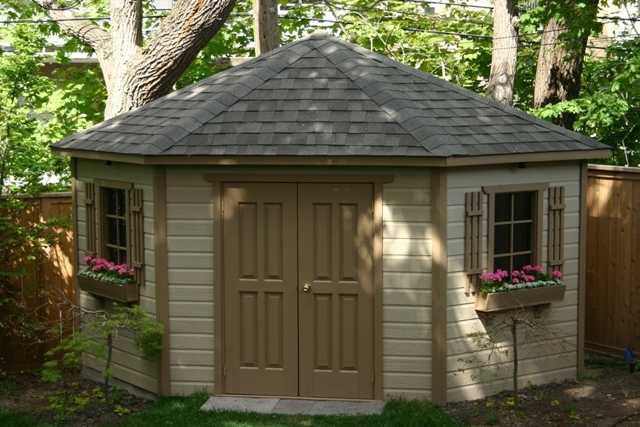 Catalina shed design 11' in a backyard with double solid delux doors seen from the front. ID number 1767