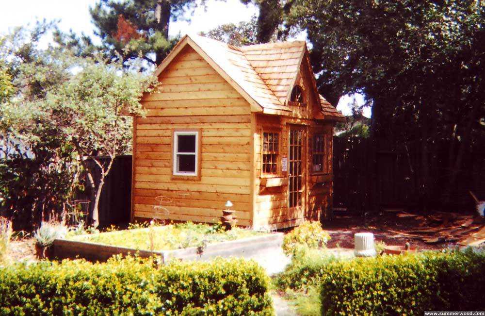 Copper creek shed design 10 x 12 in a backyard with a French door seen from the side. ID number 1909-2