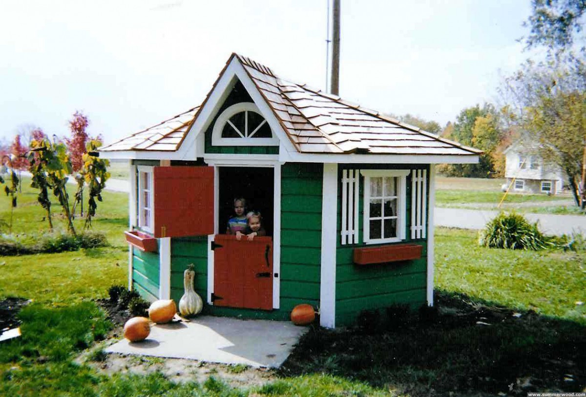 Pettite pentagon playhouse design 8' in outdoor with  flower boxes seen from front.ID number 3260-1.