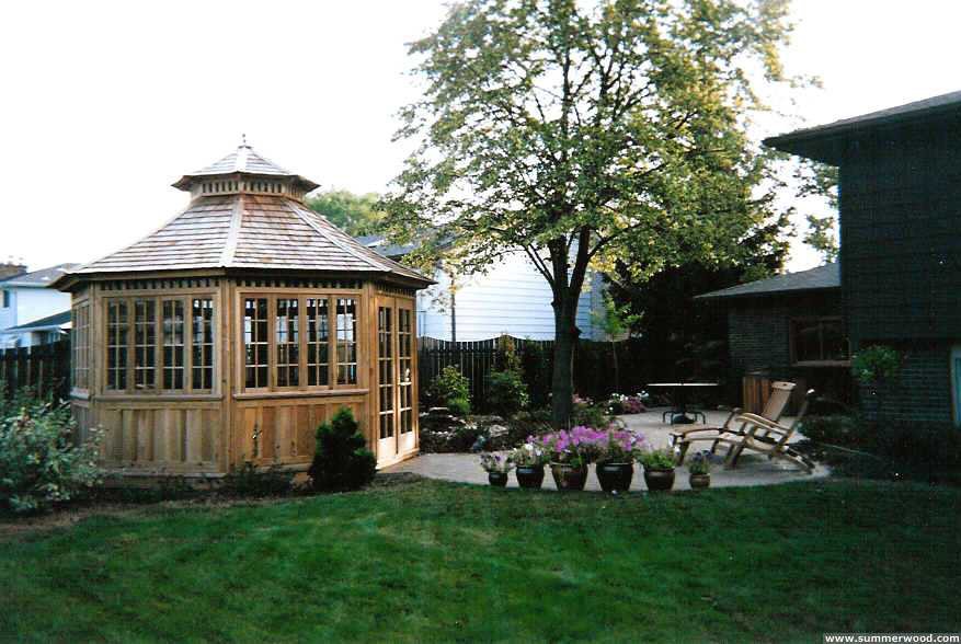 San cristobal gazebo design 14' in backyard with stained finish seen from side.ID number 3418-3.