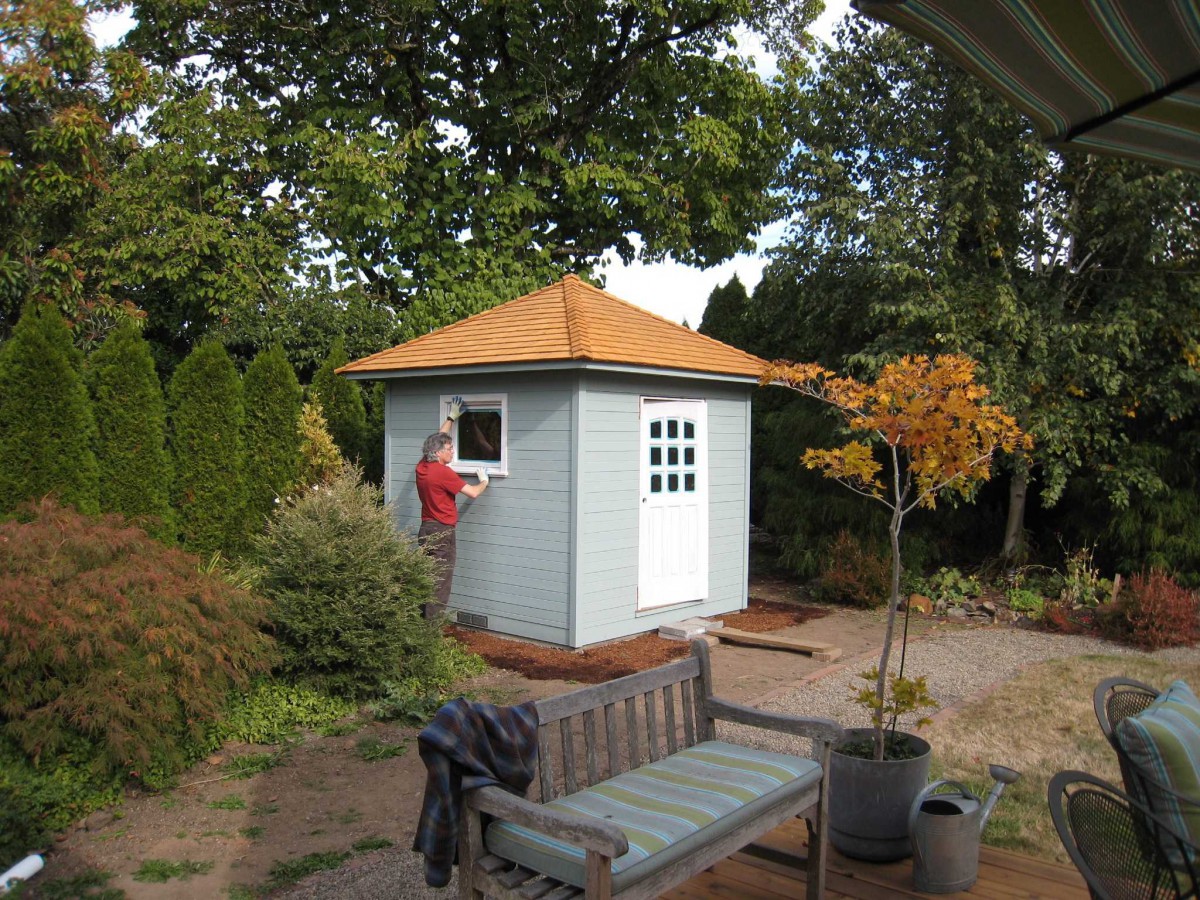 Sonoma shed design 6 x 8 in a yard with a large workshop window seen from the left. ID number 2766-1
