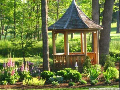 Tattle creek gazebo design 8' in garden with natural finish seen from front.ID number 2833-3.
