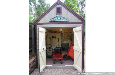 Telluride shed design 10 x 16 with a doomer window in a garden seen from the side. ID number 3290-3.