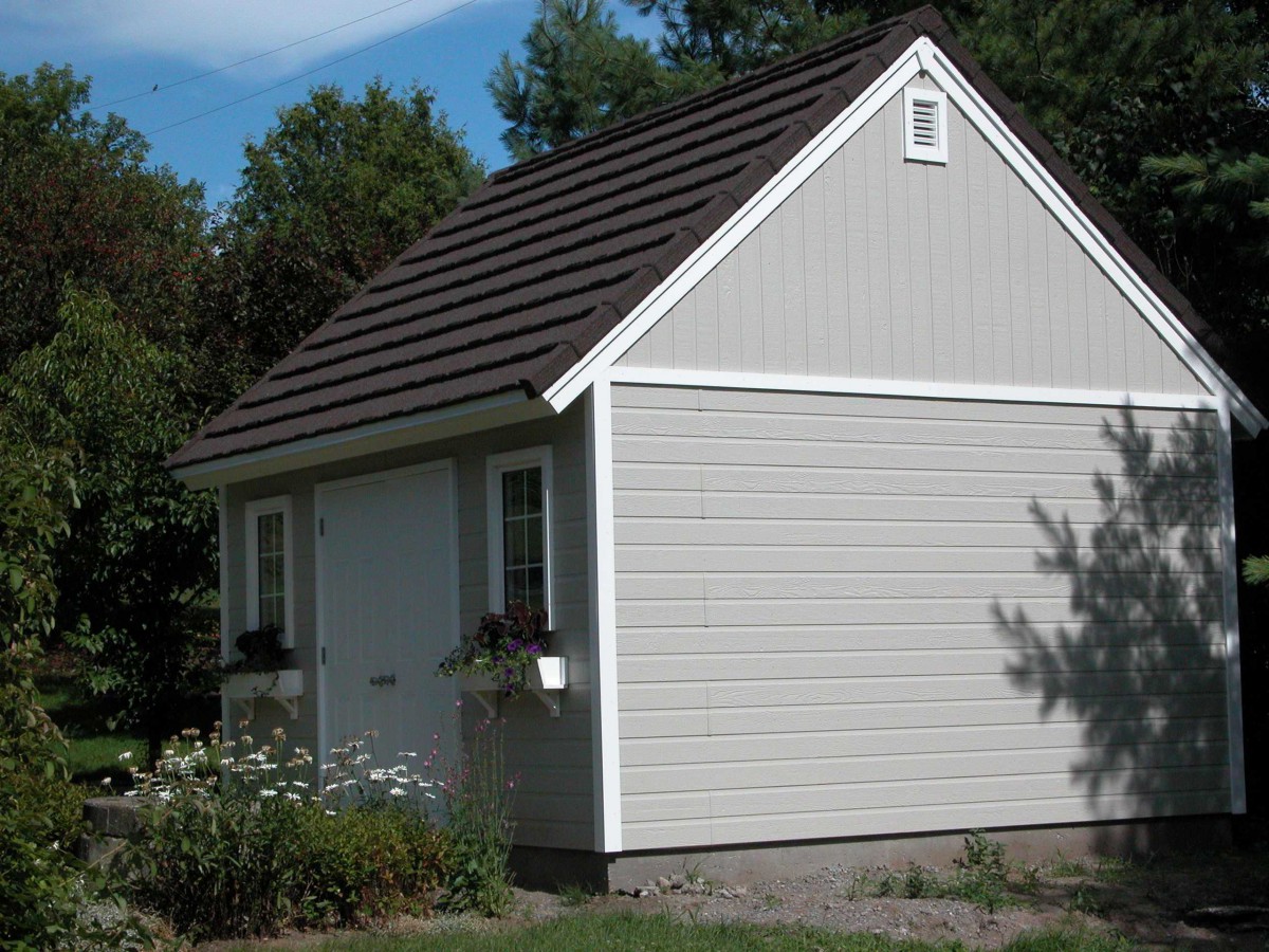 Telluride shed design 14 x 15 with white accessories in a backyard seen from the right. ID number 3278-2.
