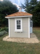Cedar Sonoma shed design 8' x 8' in a backyard featuring metal double door as seen from the front. Id number 5752.