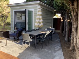 Planed cedar home studio design 10' x 12' in a backyard with metal vinyl doors in the front. ID number 5732.