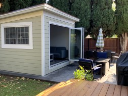 Planed cedar home studio design 10' x 12' in a backyard with metal vinyl doors in the front. ID number 5732.