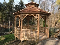 Backyard gazebo design 12' with cedar shingles and open entrance as seen from the front. Id number 5736.