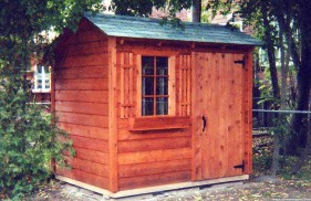 Bar harbor shed design 6 x 8 in a backyard with a standard door seen from the left. ID number 1483-1
