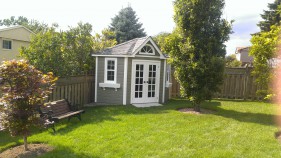 catalina home studio 9ft with french double doors in a garden seen from the front. ID number 5588
