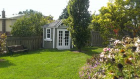 catalina home studio 9ft with french double doors in a garden seen from the front. ID number 5588