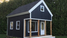 cheyenne cabin plan 14x20 with Canexel Midnight Blue Siding by a lakeside seen from the front. ID number 5586-1