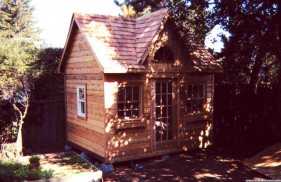 Copper creek shed design 10 x 12 in a backyard with a French door seen from the left. ID number 1909-1
