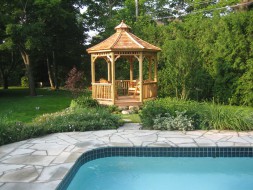 Monterey gazebo design 10' beside pool with stained finish seen from front .ID number 2721-1.