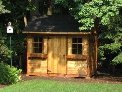 Palmerston shed design 8 x 10 with arts and crafts double doors in a backyard seen from the front. ID number 2251-1.