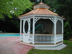Victorian gazebo design 14ft by a poolside with cedar shingles seen fron the front. ID number