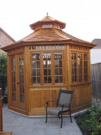 San cristobal Gazebo plan 11' in backyard with stained finish seen from right.ID number 3412-1.
