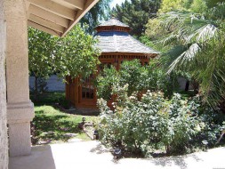 San cristobal gazebo design 16' in garden with stained finish seen from right.ID number 3426-2.