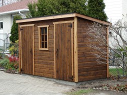 Small shed plans 5x12 in a yard with two standard single doors seen from the front. ID number 5542-1