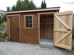 Small shed plans 5x12 in a yard with two standard single doors seen from the front. ID number 5542-1