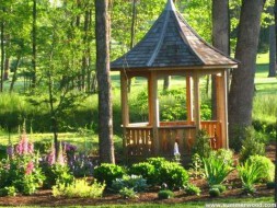 Tattle creek gazebo design 8' in garden with natural finish seen from front.ID number 2833-2.