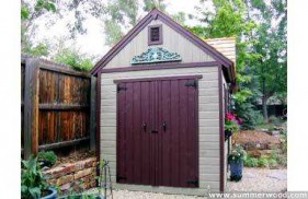 Telluride shed design 10 x 16 with a doomer window in a garden seen from the frontage. ID number 3290-1.
