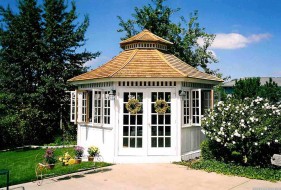 San cristobal gazebo design 16' in garden with stained finish seen from front.ID number 3398-1.