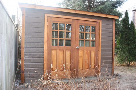 Canexel Sarawak Shed plan 5' x 10' in a backyard with 18 lite cedar double doors from the front. ID number 5742.