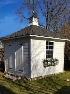 Backyard sonoma garden shed plan 10'x10' with curved double doors  in a backyard seen from the front 1. ID number 5686.