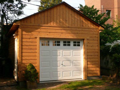 Highland DIY garage plan 14  x  20 in backyard with metal doors seen from front.ID number 3361-2.
