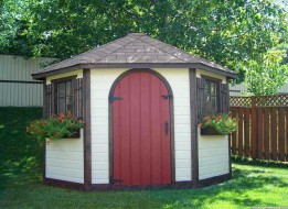 Catalina shed design 8' in a backyard with an arched door seen from the frontage. ID number 1547