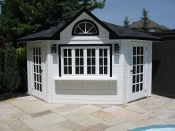 Catalina pool house design 10 ft with a fan arch window by a poolside seen from the front. ID number 3324-1.