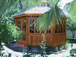 San cristobal gazebo design 16' in garden with stained finish seen from right.ID number 3426-2.