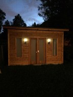 Urban studio home studio design 7 x 14 in a yard with double doors seen from front.ID number 3111-1.
